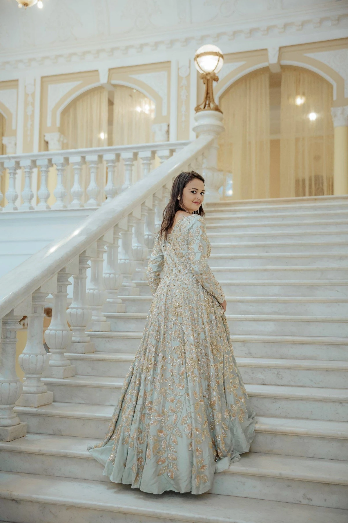 A bride on a staircase, photographed by Nuptial Diaries