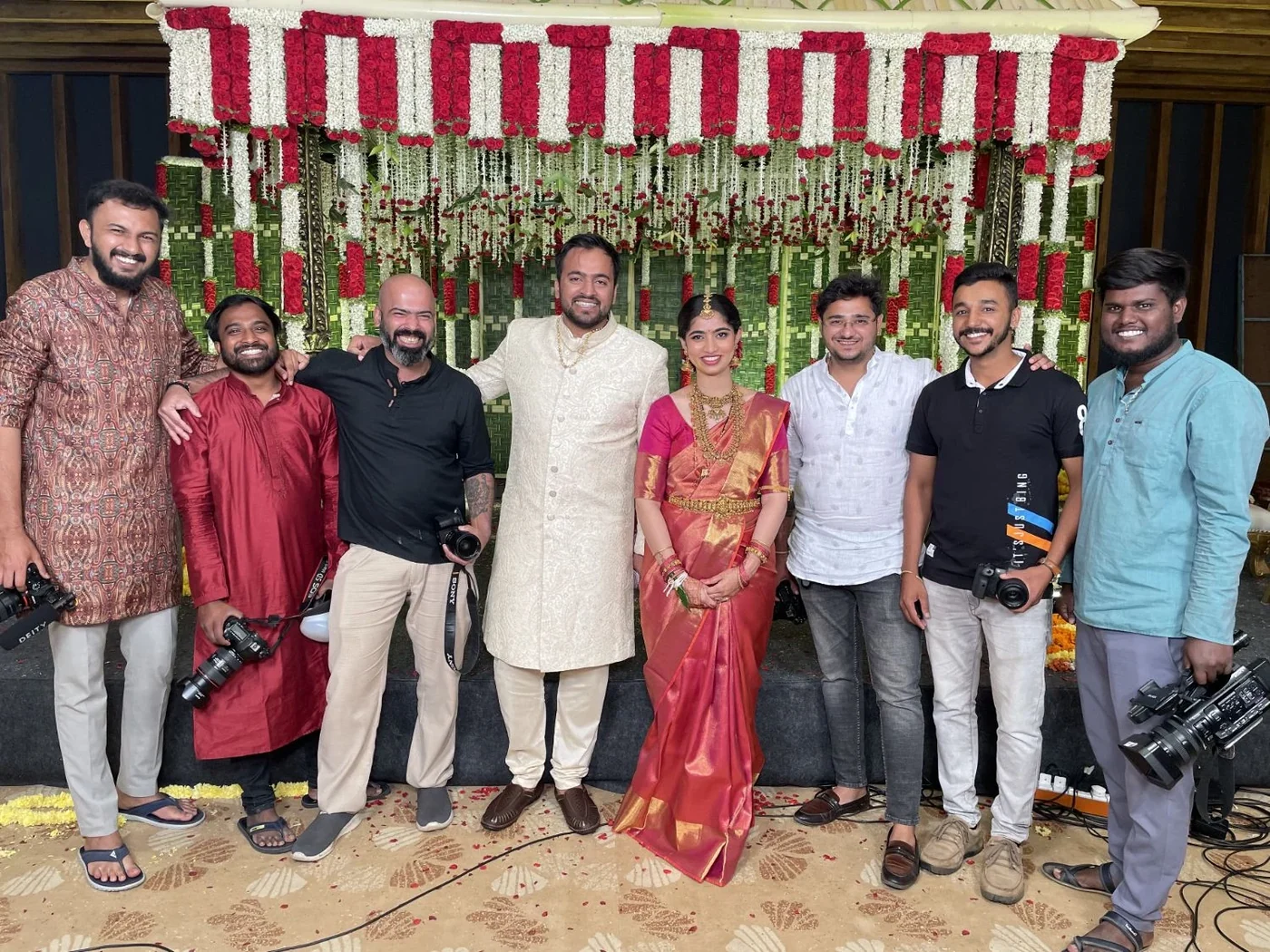The Nuptial Diaries team with a couple at their wedding